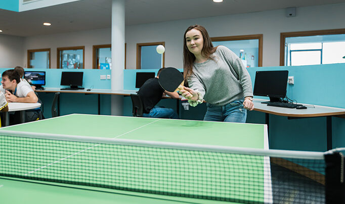 A Deeside Sixth Form student playing table tennis on the first floor