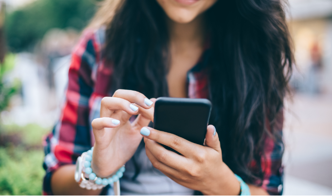 a student on their mobile phone outside of the college