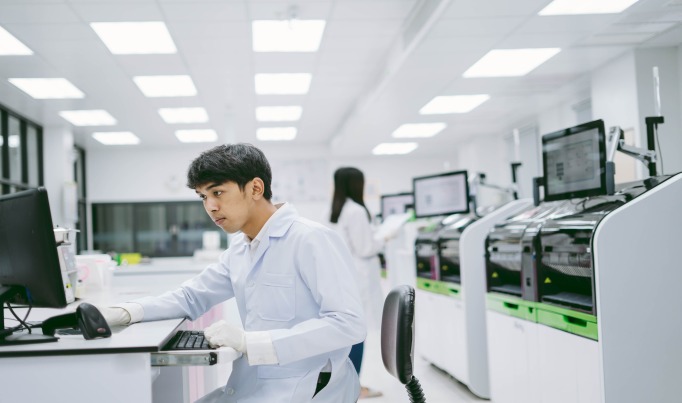 A learner in a labworking at a desk