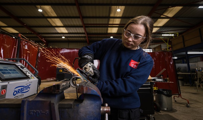 A Fabrication & Welding student using a piece of machinery to