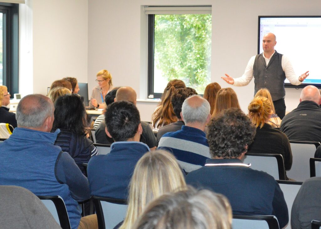 Restaurant general manager, Matt Alexander giving a talk to a group of adults