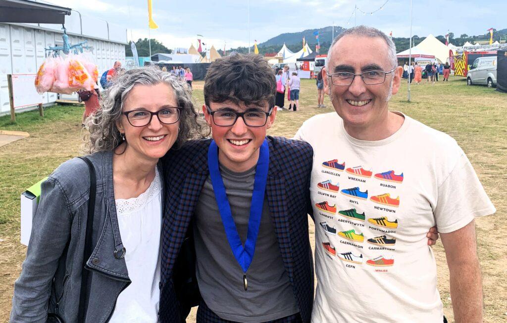 Rufus Edwards (centre) celebrating the week of a lifetime by passing his A Levels and winning a prestigious music prize.