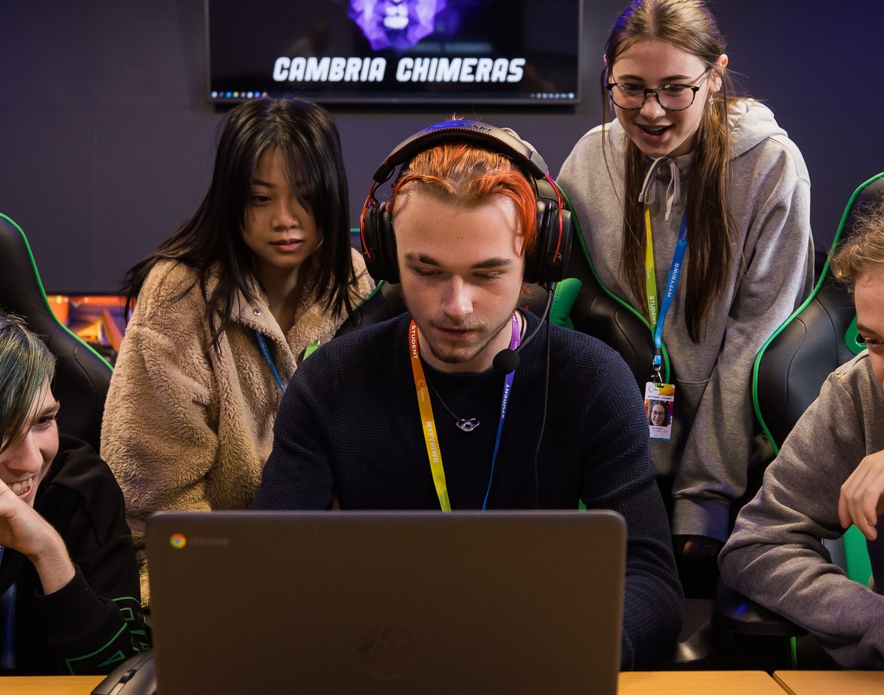 esports subject area image with a learner sat on a gaming laptop with two other students watching from behind