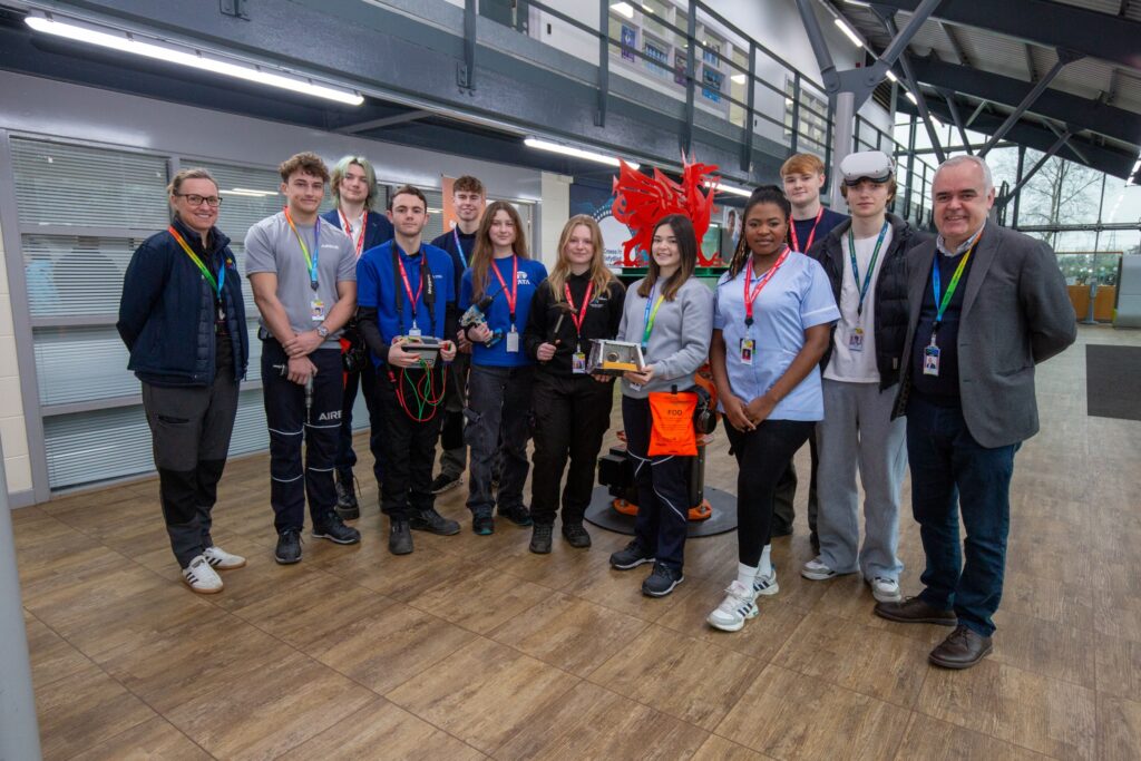 Group of students and staff with a minister