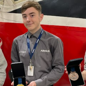 A student holding an award