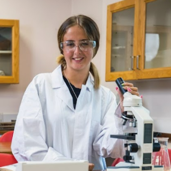 A student in a white laboratory jacket