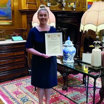 Level 2 Professional Cookery, Level 3 Professional Cookery, HND Hospitality Management Emily Jones taking a photo looking towards the camera holding a certificate