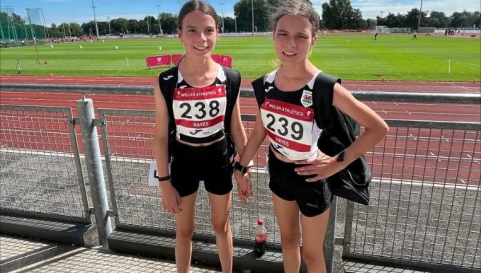 Two students standing in front of the track for a news post titled 'Supporting Young Athletes: How Our College Sports Initiative is Making an Impact'