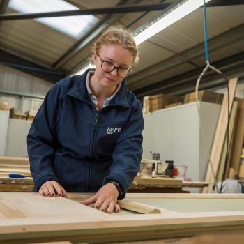 Anwyl Apprentice Hannah Jones measuring some wood using a ruler