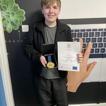 A student holding an award