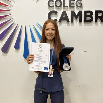 A student holding an award