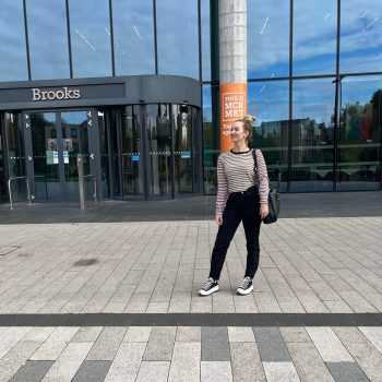 a childcare student Katy Rider stood in front of a building looking towards the camera for a hero shot