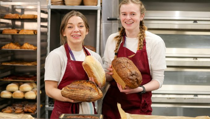 Two Cambria bakers holding loaves of bread for the news story 'The Wales Bakery Conference 2025 comes to Yale'
