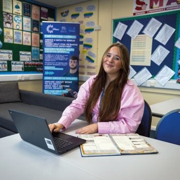 JGW learner Paige Partington sat at a table with a laptop in front of her