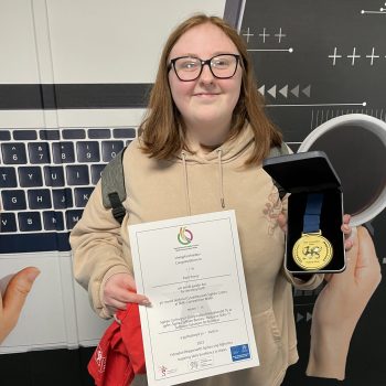 A student holding an award